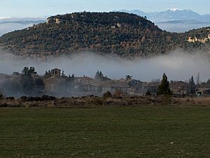 Tavertet with the Puig de les Baumes rising over the town and the Pre-Pyrenees in the far distance