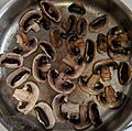 Common white mushrooms in various phases of cooking