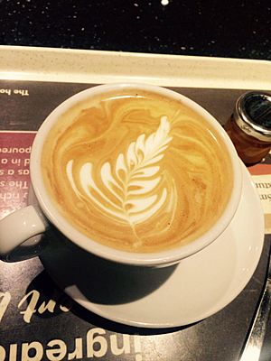 Flat white coffee with pretty feather pattern