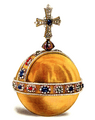 Gold ball with a cross at the top and a band of gems around the equator