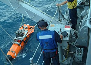 US Navy 060612-N-4124C-065 Mineman 3rd Class Dustin Moore, assigned to the mine warfare ship USS Patriot (MCM 7), retrieves a mine neutralization vehicle (MNV) after the device conducted an underwater water mine survey