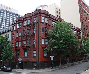 Photograph of a five-story building on a downtown street corner.