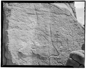 Thunderbird petroglyph at upper left, on cliff face further west of site, petroglyphs at right of undetermined origin, view towards northeast - Bee Burrow, Seven Lakes Wash, HABS NM,16-CROPO.V,1-24