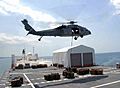US Navy 090414-F-4455C-004 An MH-60S Sea Hawk helicopter carries one of the 333 loads of cargo from the Military Sealift Command hospital ship USNS Comfort (T-AH 20) as the ship is anchored offshore near Port-Au-Prince