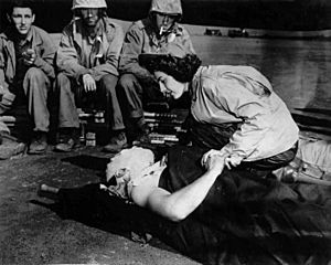 Flight nurse Jane Kendeigh caring for wounded soldier on Iwo Jima--1945