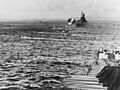 LVTs move toward Saipan, past bombarding cruisers, on 15 June 1944 (80-G-231838)