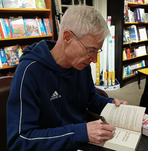 Simon Mason 2024-01-24 19.43 signing a book at Waterstones, Market Harborough