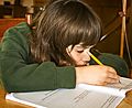 Boy doing homework (4596604619)