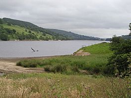 Image of a lake with steep hills beyond