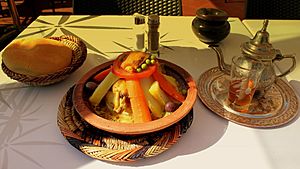 TAGINE COOKED CHICKEN AND VEGETABLES WITH MINT TEA IN JEMAA EL FNA SQUARE MARRAKECH MOROCCO APRIL 2013 (8704488002)