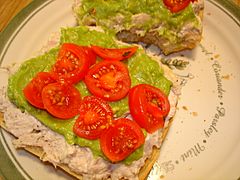 Open faced tuna sandwich with cherry tomato and guacamole spread