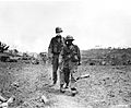 SC 207308 - Two wounded men make their way to a medical aid station on Okinawa