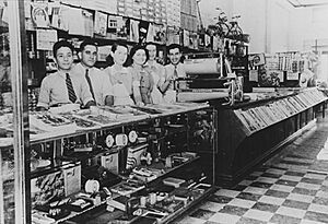 Staff behind the counter of Logos Brothers’ Central Cafe and Store, Blackall, ca. 1939