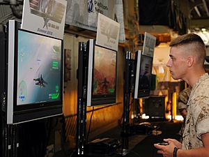 US Navy 100525-N-1831S-004 A Sailors en route to Fleet Week New York aboard the multipurpose amphibious assault ship USS Iwo Jima (LHD 7) play a demonstration copy of the new Top Gun video game