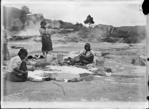 Women washing clothes in a hot pool at Whakarewarewa ATLIB 130438