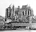 Old photo of the cathedral before completion shows the east end finished and roofed, while other parts of the building are in various stages of construction.