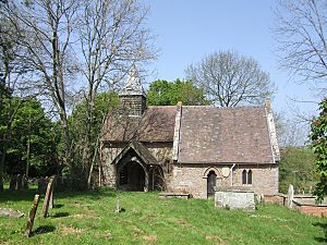 A small church seen from the south.  On the left is the short nave on top of which is a bellcote with a pyramidal tower, and on the right is the chancel