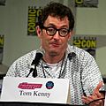 Tom Kenny seated at a microphone looking off to his left 