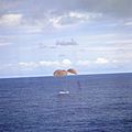 Spaceship contacts ocean under parachute