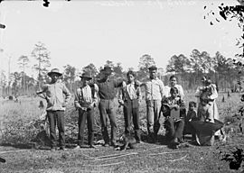 Group of Eleven Near Meadow, One in Partial Native Dress 1909.jpg