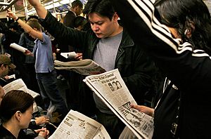 NYC subway riders with their newspapers