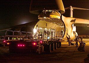 U.S. Air Force personnel unload relief supplies destined for earthquake victims in India from a C-5A Galaxy at Andersen Air Force Base, Guam