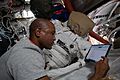 Victor Glover works on US spacesuit maintenance inside the Quest airlock 02