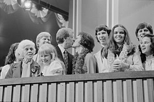 Jimmy and Rosalynn Carter kissing, surrounded by family, including Amy and Lillian, at the Democratic National Convention, New York City