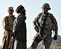Defense.gov News Photo 101030-F-2558S-074 - U.S. Navy Cmdr. Bill Mallory right commanding officer of the Nuristan Provincial Reconstruction Team listens to a Kautiak village leader in the