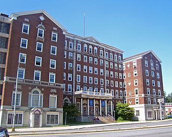 Front view of hotel, a tall brick building with two projecting wings