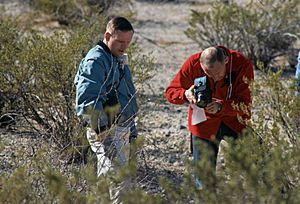 Neil (left) watches Buzz take a documentary photo of a sample