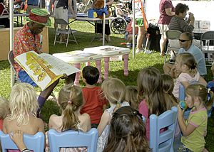 US Navy 070421-N-1280S-001 Wally Amos, founder of Famous Amos Cookies takes children on a reading adventure during Springfest