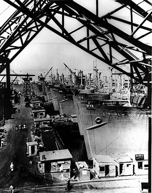 Victory cargo ships are lined up at a U.S. west coast shipyard