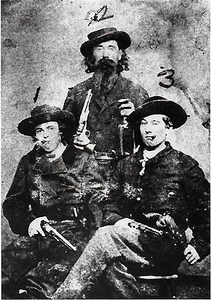 Arch Clements, Dave Pool, and Bill Hendricks brandishing revolvers