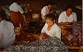 Batik craftswomen in Java handmarking resist on batik tulis cloth with tjantings