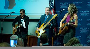 Former Arkansas Governor Mike Huckabee play bass guitar with recording artist Ayla Brown in 2015