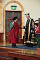 PhD graduand shaking hands with Sir Dominic Cadbury, the Chancellor of the University of Birmingham - 20120705