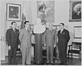 Photograph of President Truman receiving a marble bust of Simon Bolivar from a Venezuelan delegation in the Oval... - NARA - 199531