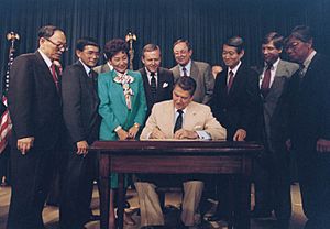Ronald Reagan signing Japanese reparations bill