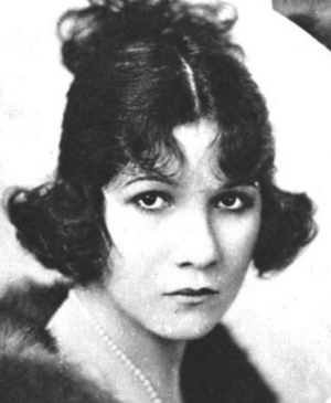 A young white woman with dark hair in a curled bob