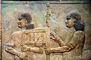 Assyrian eunuchs carrying Sargon II's throne
