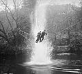 Commandos cross a river on a 'toggle bridge' under simulated artillery fire at the Commando training depot at Achnacarry in Scotland, January 1943. H26620