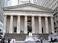 Neoclassical building with doric columns and a statue of George Washington