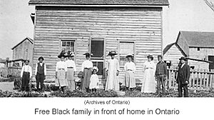 Free Black family in front of home in Ontario