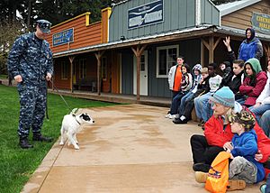 US Navy 100401-N-4649C-004 Children participating in a Kids' Day Deployment meet Zorro, a military working dog and his handler, Master-At-Arms 1st Class Josh Vanorden, from Naval Base Kitsap Security