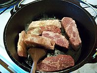 Browning pork in a black pot HRoe 2012