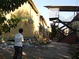 Diego Grez in front of destroyed apartments in Paniahue, Santa Cruz, Chile