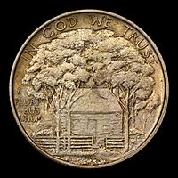 Silver dollar with a house shaded by trees