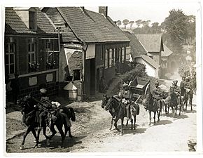 Indian cavalry marching through a French village (near Fenges). Photographer- H. D. Girdwood. (13874804275)