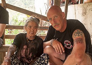 Whang-od and a recently tattooed visitor.